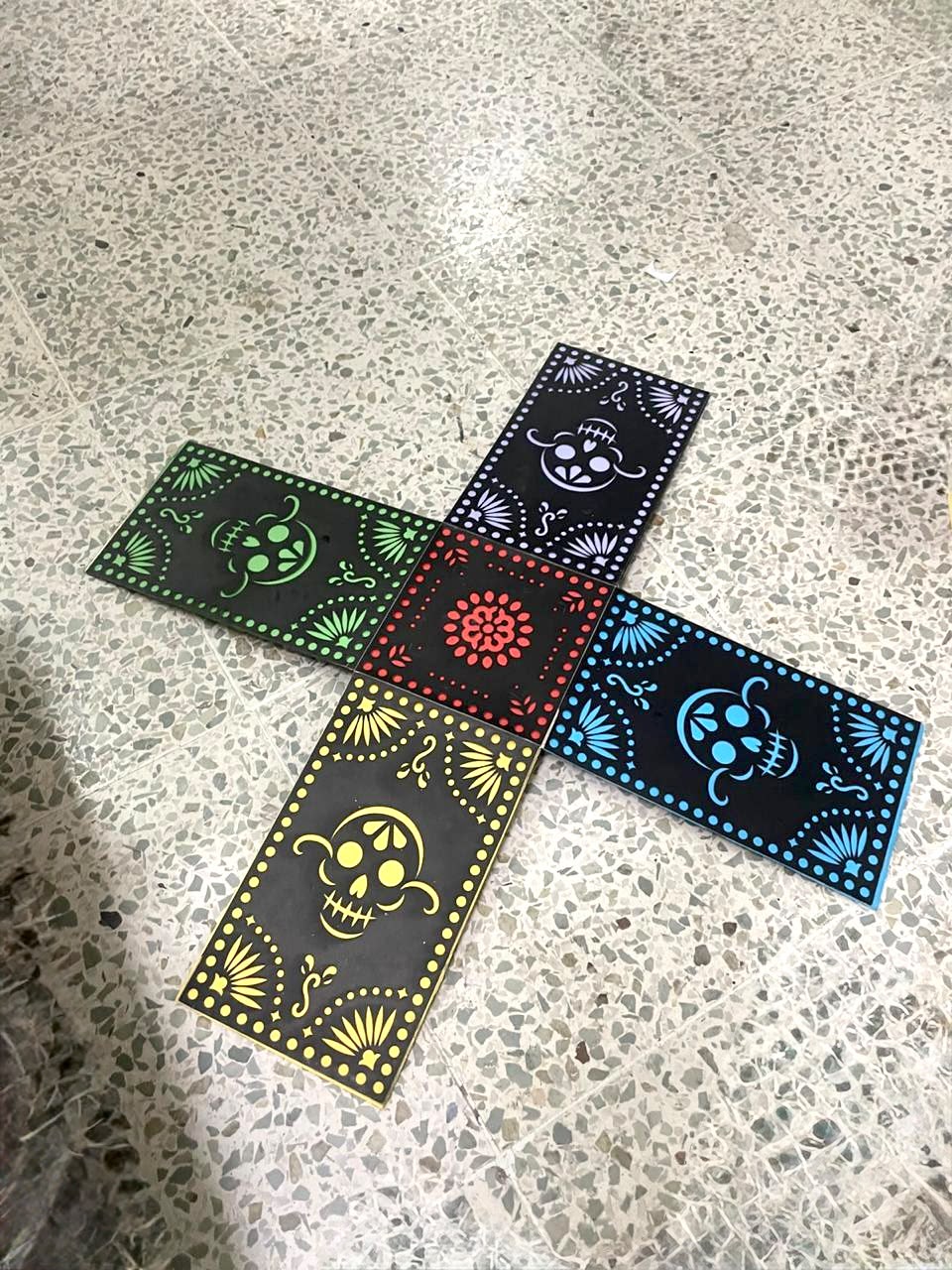 Five picado panels, each pierced and backed with a different colour sheet, laid in a cross