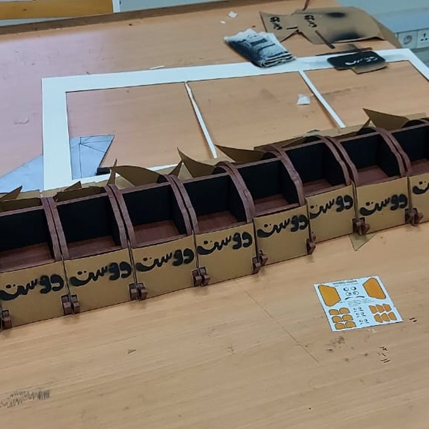 Batch of Dost units in production on the bench with sticker sheets