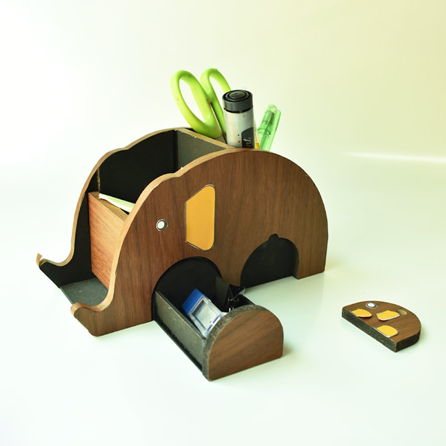 Finished Dost prototype in walnut veneer, drawer open, keychain alongside