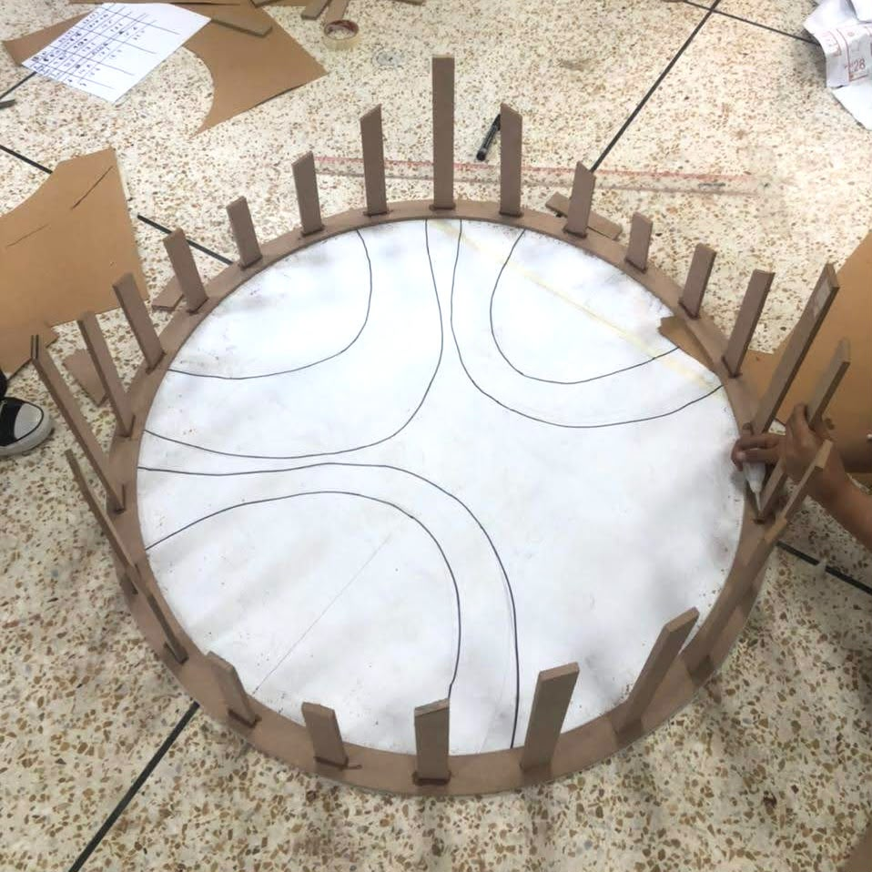Plywood base ring with radial ribs on the studio floor