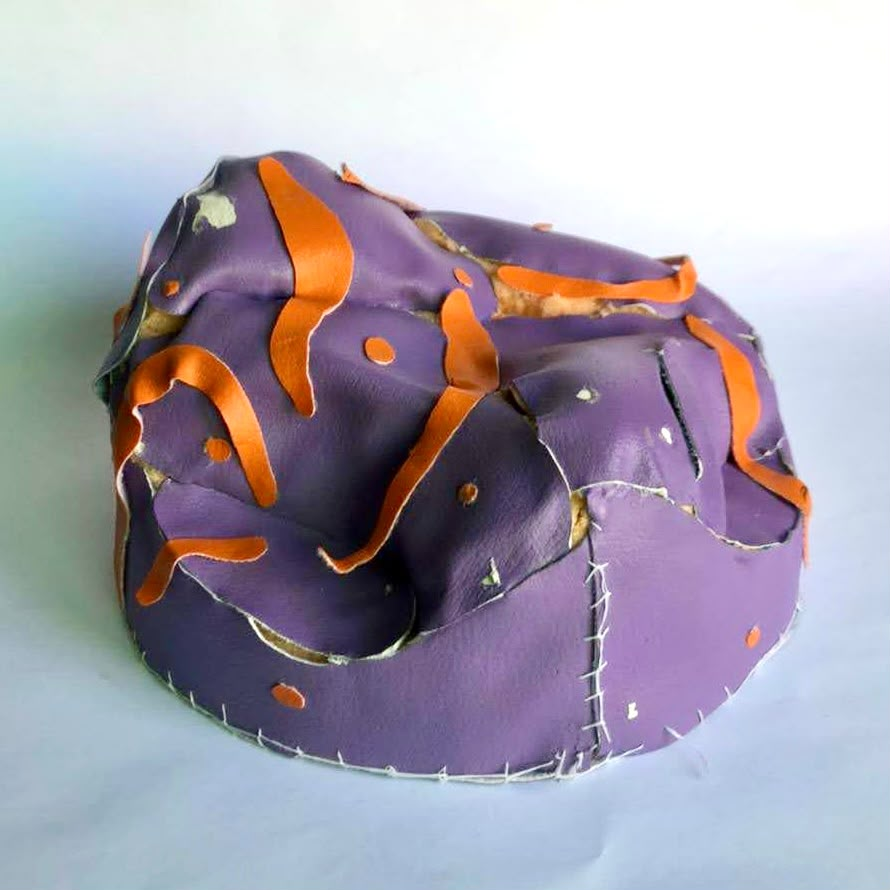 Model skinned in purple and orange rexine, hand-stitched