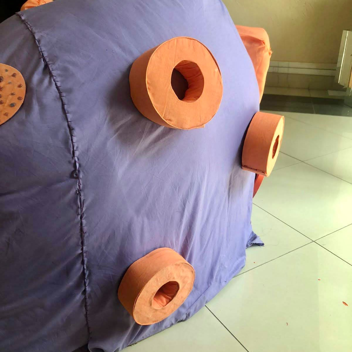 Padded orange rings velcroed onto the purple base