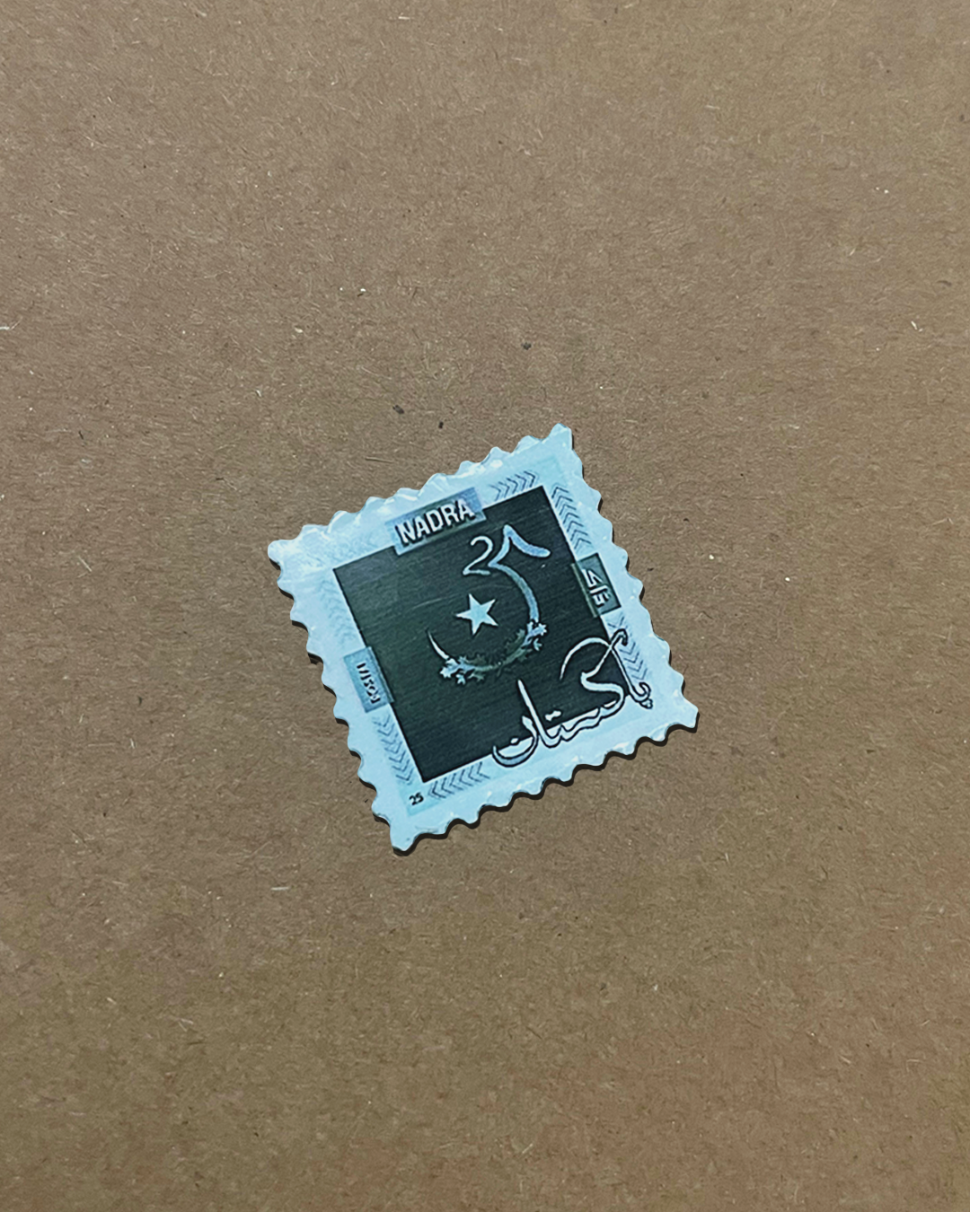 The stamp cut out at actual size on kraft paper